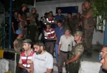 Turkish gendarmeries escort fugitive commandos who were involved in a bid to seize President Tayyip Erdogan during a failed coup attempt last month, as they leave from a gendarmerie station in Mugla province, Turkey, August 1, 2016. PHOTO BY REUTERS/Kenan Gurbuz
