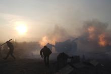 Ukrainian servicemen fire an artillery weapon in the direction of positions of the armed forces of the separatist self-proclaimed Donetsk People's Republic near Novoluhanske in Donetsk region, Ukraine, January 2018. PHOTO BY REUTERS/Maksim Levin