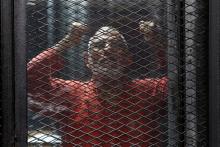 Muslim Brotherhood's leader Mohamed Badie shouts slogans against the Interior Ministry behind bars during the trial of 738 brotherhood members for their armed sit-in at Rabaa square, at a court on the outskirts of Cairo, Egypt, May 31, 2016. PHOTO BY REUTERS