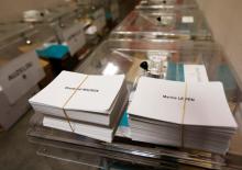 Ballots with the names of 2017 French presidential election candidates Emmanuel Macron (L) and Marine Le Pen are seen near ballot boxes on the eve of the second round of the French presidential election, at a polling station in Tulle, France, May 6, 2017. PHOTO BY REUTERS/Regis Duvignau