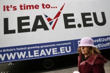 A woman walks past a Leave.EU campaign mobile advertising board in central London, Britain, November 18, 2015. PHOTO BY REUTERS/Stefan Wermuth
