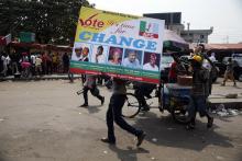 A man carries a banner campaigning for All Progressives Congresses candidates outside a campaign rally in Yaba district in Lagos, February 5, 2015. PHOTO BY REUTERS/Akintunde Akinleye