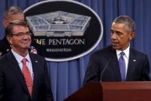 U.S. President Barack Obama (R) acknowledges Defense Secretary Ash Carter (L) in his remarks after a briefing on U.S. efforts against the Islamic State (ISIS), at the Pentagon in Arlington, Virginia July 6, 2015. PHOTO BY REUTERS/Jonathan Ernst