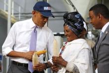 U.S. President Barack Obama (L) speaks with a farmer (2nd R) participating in the Feed the Future program as he tours the Faffa Food factory in Addis Ababa, Ethiopia, July 28, 2015. PHOTO BY REUTERS/Jonathan Ernst