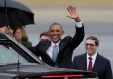 U.S. President Barack Obama waves while standing in front of Cuba's foreign minister Bruno Rodriguez (R) after he arrived at Havana's international airport for a three-day trip, in Havana, March 20, 2016. PHOTO BY REUTERS/Enrique De La Osa
