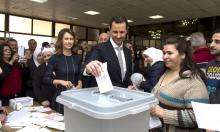 Syria's President Bashar al-Assad (C) casts his vote next to his wife Asma (centre left) inside a polling station during parliamentary elections in Damascus, Syria, in this handout picture provided by SANA April 13, 2016. PHOTO BY REUTERS/SANA