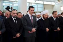 Syria's President Bashar al-Assad (2nd L) attends Eid al-Fitr prayers at al-Hamad mosque in Damascus, Syria, in this handout released by Syria's national news agency SANA, July 17, 2015. PHOTO BY REUTERS/SANA