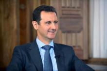 Syria's President Bashar al-Assad answers questions during an interview with al-Manar's journalist Amro Nassef, in Damascus, Syria, in this handout photograph released by Syria's national news agency SANA, August 25, 2015. PHOTO BY REUTERS/SANA