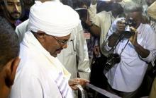 Sudan's President Omar Hassan al-Bashir (C) casts his ballot during elections in the capital Khartoum, April 13, 2015. PHOTO BY REUTERS/Mohamed Nureldin Abdallah