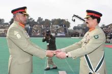 Pakistan's outgoing Army Chief Gen. Raheel Sharif (R) hands over a ceremonial baton to his successor Gen. Qamar Javed Bajwa during the Change of Command ceremony in Rawalpindi, Pakistan, November 29, 2016. PHOTO BY REUTERS/Pakistan Inter Services Public Relations (ISPR)