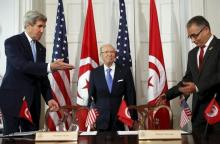 U.S. Secretary of State John Kerry (L) and Tunisian President Beji Caid Essebsi (C) with Minister for Political Affairs Mohsen Marzouk arrive to sign a memorandum of understanding in Washington, May 20, 2015. PHOTO BY REUTERS/Yuri Gripas