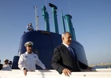 Israeli Prime Minister Benjamin Netanyahu (R) walks on the Rahav, the fifth submarine in the fleet, after it arrived in Haifa port, January 12, 2016. PHOTO BY REUTERS/Baz Ratner