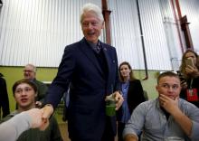 Former U.S. President Bill Clinton (C) greets customers and employees while campaigning for his wife, Democratic presidential candidate Hillary Clinton, at the NewBo Market in Cedar Rapids, Iowa in this January 7, 2016 file photo. PHOTO BY REUTERS/Aaron P. Bernstein