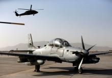 A Blackhawk helicopter flies above a parked A-29 Super Tucano aircraft, during a handover ceremony of Blackhawk helicopters from U.S. to the Afghan forces, at the Kandahar Air base, Afghanistan October 7, 2017. PHOTO BY REUTERS/Omar Sobhani