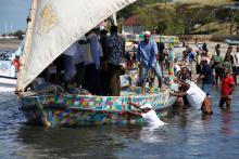 People push Flipflopi, the first dhow boat made entirely of recycled plastic into the water, as it takes its first voyage sail, after the launch ceremony on the island of Lamu, Kenya, September 15, 2018. PHOTO BY REUTERS/Baz Ratn