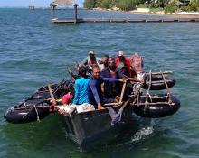 A home-made aluminum boat carrying 16 Cuban migrants pulls up to a dock seeking what the migrants said was refuge from rough seas, in Grand Cayman island