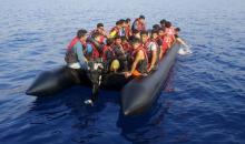 Migrants wait on a dinghy with a broken motor following an attempt to reach the Greek Island of Kos after leaving Bodrum, Turkey, September 20, 2015. PHOTO BY REUTERS/Umit Bektas