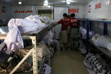 Volunteers stand amid bodies, several of which are people who died due to an intense heatwave, according to Edhi Foundation, at Edhi morgue in Karachi, Pakistan, May 22, 2018. PHOTO BY REUTERS/Akhtar Soomro