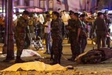 Bodies of victims are covered with white sheet as security forces and emergency workers gather at the scene of the blast in central Bangkok, August 17, 2015. PHOTO BY REUTERS/Athit Perawongmetha