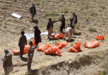 Villagers collect the dead bodies of civilians who were killed by insurgents at Mirza Olang village, in Sar-e Pul province, Afghanistan, August 15, 2017. PHOTO BY REUTERS/Stringer