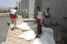 Yemeni Red Crescent workers stand next to the bodies of Houthi fighters placed inside plastic bags in Yemen's southwestern city of Taiz, March 13, 2016. PHOTO BY REUTERS/Anees Mahyoub