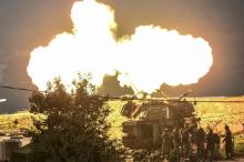 An Israeli artillery gun fires a shell into Lebanon, after a roadside bomb exploded next to an Israeli military border patrol near the Shebaa Farms area on Monday, near Kiryat Shmona, Israel, January 4, 2016. PHOTO BY REUTERS/Ancho Gosh
