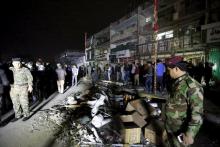 Iraqi security forces gather at the site of a car bomb in New Baghdad, January 11, 2016. PHOTO BY REUTERS/Ahmed Saad