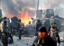 Iraqi Special Operations Forces (ISOF) react after a car bomb exploded during an operation to clear the al-Andalus district of Islamic State militants, in Mosul, Iraq. PHOTO BY REUTERS/Muhammad Hamed