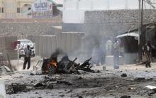 Security personnel gather at the scene of an explosion near the entrance of the airport in Somalia's capital Mogadishu