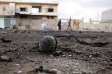 An unexploded cluster bomblet is seen along a street after airstrikes by pro-Syrian government forces in the rebel held al-Ghariyah al-Gharbiyah town, in Deraa province, Syria, February 11, 2016. PHOTO BY REUTERS/Alaa Al-Faqir