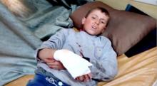 A boy lies on a bed with an injured hand after what is said to be a missile attack on a hospital in Azaz, Aleppo, Syria, February 15, 2016 in this still image taken from a video on a social media website. PHOTO BY REUTERS/Social Media Website via Reuters TV