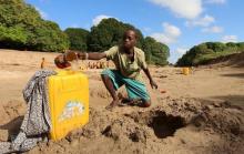 A Somali boy collects water from a well dug in the Shabelle River bed, which is dry due to drought in Somalia's Shabelle region, March 19, 2016. PHOTO BY REUTERS/Feisal Omar