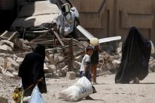Displaced Iraqi people carry their belongings as they flee from western Mosul, Iraq May 31, 2017. PHOTO BY REUTERS/Alkis Konstantinidis