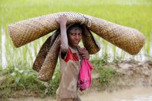 A Rohingya refugee boy reacts to the camera as he walks in the water after crossing the Bangladesh-Myanmar border in Teknaf, Bangladesh, September 1, 2017. PHOTO BY REUTERS/Mohammad Ponir Hossainin