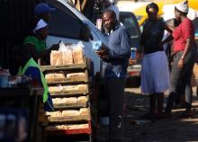 A man buys bread from a street vendor in Mbare township, Harare, Zimbabwe, January 24, 2019. PHOTO BY REUTERS/Philimon Bulawayo