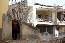 A man stands next to a building, damaged after a truck bomb attack on a nearby police station, in Cinar in the southeastern city of Diyarbakir, Turkey, January 14, 2016. PHOTO BY REUTERS/Sertac Kayar