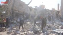 People gather near a destroyed building said to be a Medecins Sans Frontieres (MSF) supported hospital in Marat al Numan, Idlib, Syria, February 15, 2016 in this still image taken from a video on a social media website. PHOTO BY REUTERS/Social Media Website via Reuters TV