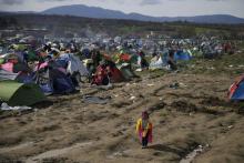 A young migrant, who is waiting to cross the Greek-Macedonian border, stands at a makeshift camp near the village of Idomeni, Greece, March 8, 2016. PHOTO BY REUTERS/Marko Djurica
