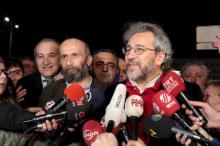 Can Dundar, editor-in-chief of Cumhuriyet, (R), accompanied by his Ankara bureau chief Erdem Gul, speaks to the media after being released from prison outside the Silivri prison complex near Istanbul, Turkey early, February 26, 2016. PHOTO BY REUTERS/Can Erok