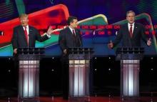 Republican U.S. presidential candidate businessman Donald Trump (L) responds to criticism from former Governor Jeb Bush (R) as Senator Ted Cruz (C) looks on during the Republican presidential debate in Las Vegas, Nevada, December 15, 2015. PHOTO BY REUTERS/Mike Blake
