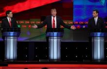 Republican U.S. presidential candidate Donald Trump (C) speaks as rivals Marco Rubio (L) and Ted Cruz listen during the Republican U.S. presidential candidates debate sponsored by CNN at the University of Miami in Miami, Florida, March 10, 2016. PHOTO BY REUTERS/Carlo Allegri