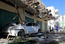 A damaged car is seen at the scene of the afternoon blast near Al Kowsar supermarket in the capital Mogadishu, December 19, 2015. PHOTO BY REUTERS/Feisal Omar