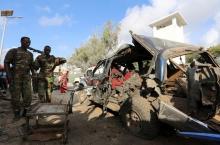 Somali policemen look at the wreckage of a car at the scene of an explosion following an attack in Somalia's capital Mogadishu, March 9, 2016. PHOTO BY REUTERS/Feisal Omar