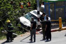 Israeli security forces and emergency personnel inspect the scene of a Palestinian car ramming attack near the Jewish settlement of Ofra near the West Bank city of Ramallah, April 6, 2017. PHOTO BY REUTERS/Mohamad Torokman
