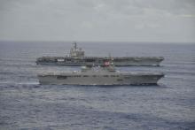 USS Ronald Reagan (rear), a Nimitz-class nuclear-powered supercarrier, sails side-by-side with Japan Maritime Self-Defense Force's Hyuga-class helicopter destroyer Ise (DDH-182) during their joint military drill in the sea off Japan, September 14, 2017. PHOTO BY REUTERS/Japan Maritime Self-Defense Force