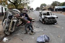 Scrap metal collectors prepare to transport a shell of a car after it was burnt during xenophobic attacks that took place earlier this week in Johannesburg, South Africa, September 5, 2019. PHOTO BY REUTERS/Siphiwe Sibeko