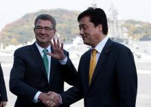 U.S. Defense Secretary Ash Carter (L) shakes hands with Japan's vice Minister of Defense Kenji Wakamiya on the deck of the Izumo, Japan Maritime Self Defense Force's (JMSDF) helicopter carrier, at JMSDF Yokosuka base in Yokosuka, south of Tokyo, Japan, December 6, 2016. PHOTO BY REUTERS/Kim Kyung-Hoon