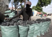 A trader arranges charcoal inside sacks along a street near the main Baraka market in Mogadishu
