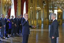The chief of Belgium's Francophone Liberal Party (MR) Charles Michel (L) is sworn in as Prime Minister in the presence of King Philippe (R) at the Brussels Royal Palace in Brussels