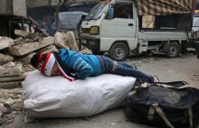 A child sleeps while waiting to be evacuated with others from a rebel-held sector of eastern Aleppo, Syria, December 17, 2016. PHOTO BY REUTERS/Abdalrhman Ismail